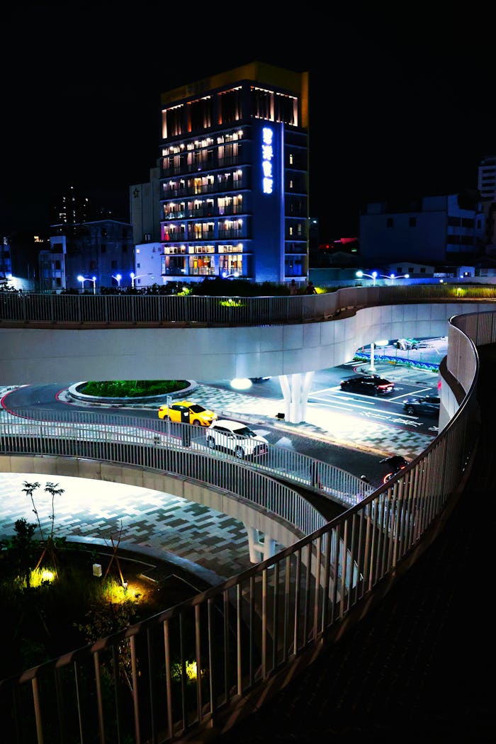 home-services-03 Brightly lit urban street with modern architecture and traffic in Taiwan at night, showcasing vibrant city life.